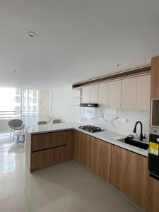 a kitchen with a sink and a stove top oven at Apartamento Sur de Cali in Cali