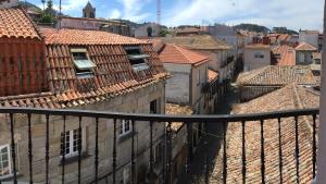 a view from a balcony of a city with roofs at Hotel Bayona in Baiona