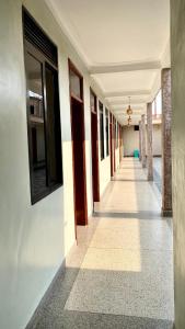 an empty hallway of a building with a row of doors at Safari Hotel Lyantonde in Lyantonde