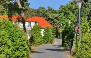 a driveway with trees and a house with an orange roof at Gorgeous Apartment In Altenkirchen With Wifi in Altenkirchen