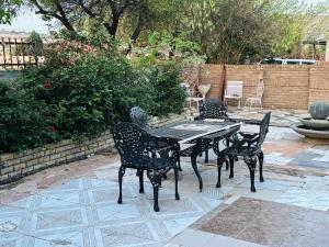 a black table and chairs on a patio at Nalana Guest House in Thaba Nchu +10 photos