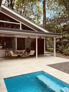 a patio with a swimming pool next to a house at Casa Clara in Uvita