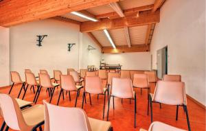 a room with rows of chairs and a table in it at Beach Front Apartment In Altenkirchen With Wifi in Altenkirchen