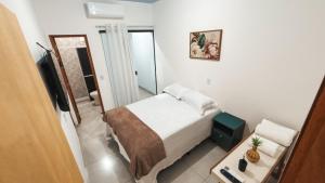 a small bedroom with a bed and a television at Residencial Antônio Floriza in Sinop