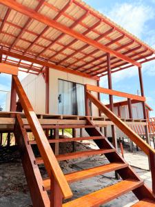 a wooden staircase leading up to a building at Nossos Chalés de Praia in Bragança +7 photos