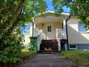 a white house with a porch and stairs at Centrally located holiday home in Stöllet in Stöllet