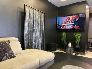 a living room with a white couch and a flat screen tv at Knez in Belgrade