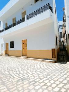 a white building with two doors on the side at Casa Di Sofra in Sousse