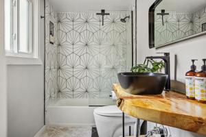 a bathroom with a tub and a toilet and a sink at TreeLicious Jacuzzi Cozy Chalet close to Slopes in Big Bear Lake +45 photos