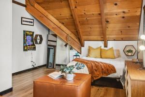 a bedroom with a large bed and wooden ceilings at TreeLicious Jacuzzi Cozy Chalet close to Slopes in Big Bear Lake