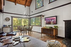a large living room with a table and chairs at TreeLicious Jacuzzi Cozy Chalet close to Slopes in Big Bear Lake