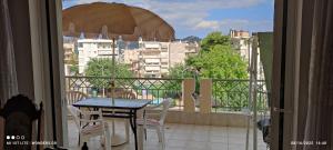 a balcony with a table and chairs and a view of a city at Delux 3 Bedroom Apartment Exceptional Location in Sparti