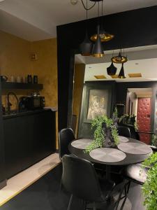 a kitchen and dining room with a table and chairs at Knez in Belgrade +7 photos