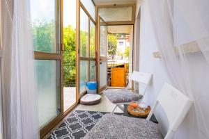 a small room with two chairs and a window at The Loft in Koper