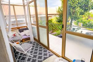 a screened in porch with a chair and a couch at The Loft in Koper