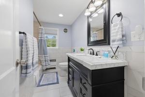 a bathroom with a sink and a toilet and a mirror at Secluded Sanctuary in Nature in Monroe +23 photos