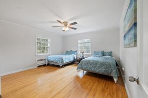 a bedroom with two beds and a ceiling fan at Secluded Sanctuary in Nature in Monroe +23 photos