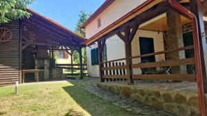 a courtyard of a house with a wooden fence at Valiug Crivaia in Văliug