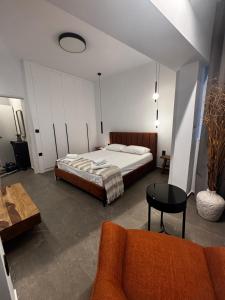 a bedroom with a bed and a table and a couch at Melissa luxury apartment in Mytilini