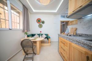 a kitchen with a table and a chair in it at Dar Diafa Anza in Agadir