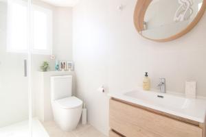 a bathroom with a toilet and a sink and a mirror at RiuRau Home - Studio 50 meters from the beach in Calpe