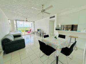 a living room with a table and a couch at Seaside Serenity in San Juan
