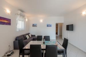 a living room with a table and a couch at Apartment Rita in Preko