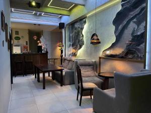 a restaurant with tables and chairs in a room at Хостел Піонер in Sumy