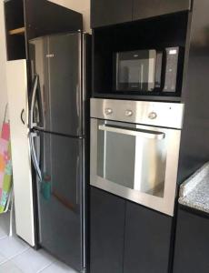 a kitchen with a black refrigerator and a microwave at Hogar de descanso in Mendoza