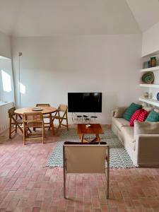 a living room with a couch and a table at Dona Ana House in Tavira