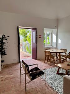 a living room with a table and a chair at Dona Ana House in Tavira
