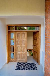 a large wooden door with a rug in front of it at Casa tranquila in Kigali