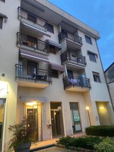 a tall white building with balconies on it at Casa dell'Orso Biella in Biella