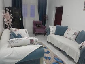 a living room with two couches and a chair at yaso apartment in Cairo