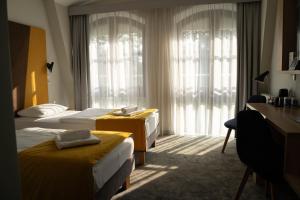 a hotel room with two beds and a desk at Villa Ozone in Sopot +34 photos