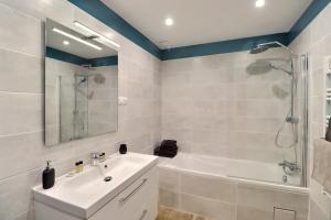 a bathroom with a white sink and a shower at The Maisonnette in the pines in Ventabren