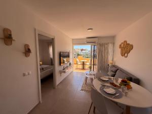 a living room with a dining table and a living room at Sunny Apartment Loma de Arguineguín in Arguineguín