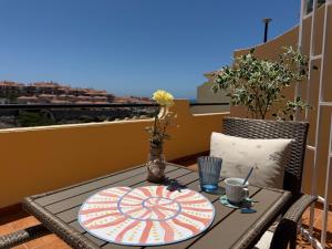 a table with a plate on top of a balcony at Sunny Apartment Loma de Arguineguín in Arguineguín