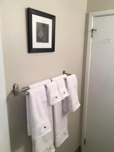 a bathroom with white towels hanging on a towel rack at Cameron Village Modern Stylish Condo in Raleigh