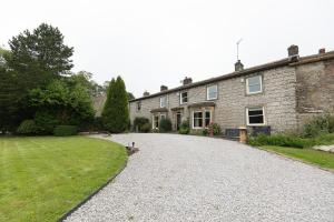 a large stone house with a gravel driveway at RAYGILL HOUSE - Spacious Family Retreat in Scenic North Yorkshire in Lothersdale