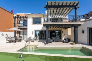 a house with a swimming pool and a patio at Luxe 5 BDRM Copala Villa GOLF Minutes to Marina in Cabo San Lucas