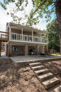 a large brick house with a porch and a deck at The Dock House in Mooringsport