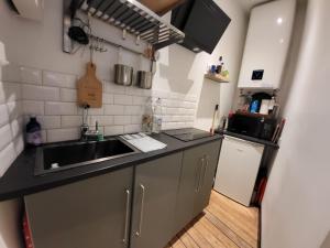 a small kitchen with a sink and a counter top at Morny Belvédère in Deauville