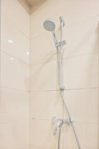 a shower with a shower head in a bathroom at Beautiful Apartment city center in Vienna