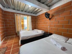 a room with two beds and a window at Cabaña Campestre in Puerto Triunfo +44 photos