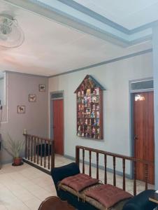 a living room with a couch and a stair case at 3 BR Spacious and Cozy Bungalow House in Dulongabong