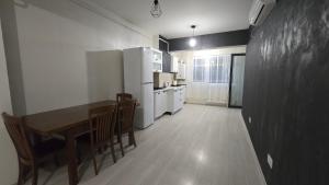 a kitchen with a table and chairs and white appliances at Stroe House in Iaşi