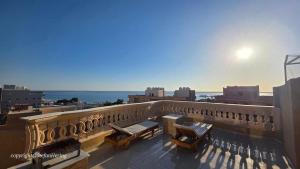 a balcony with a view of the ocean at Safaga SeaView Rooftop in Safaga