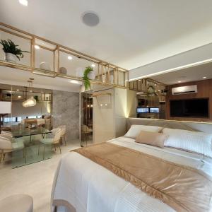 a bedroom with a large bed and a dining room at FLAT LUXO em BOA VIAGEM Prox PRAIA, SHOPPING e AEROPORTO in Recife +64 photos