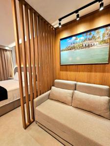 a living room with a couch and a bed at Luxuoso e sofisticado Beach Class Summer by HM in Porto De Galinhas